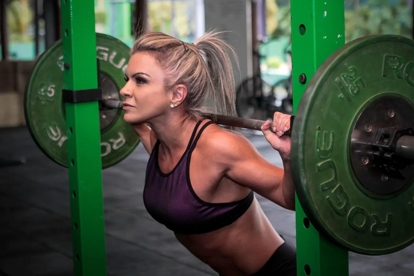 A barbell back squat in a power rack