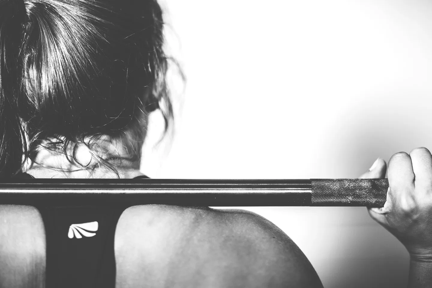 A loaded barbell ready to lift, in black and white