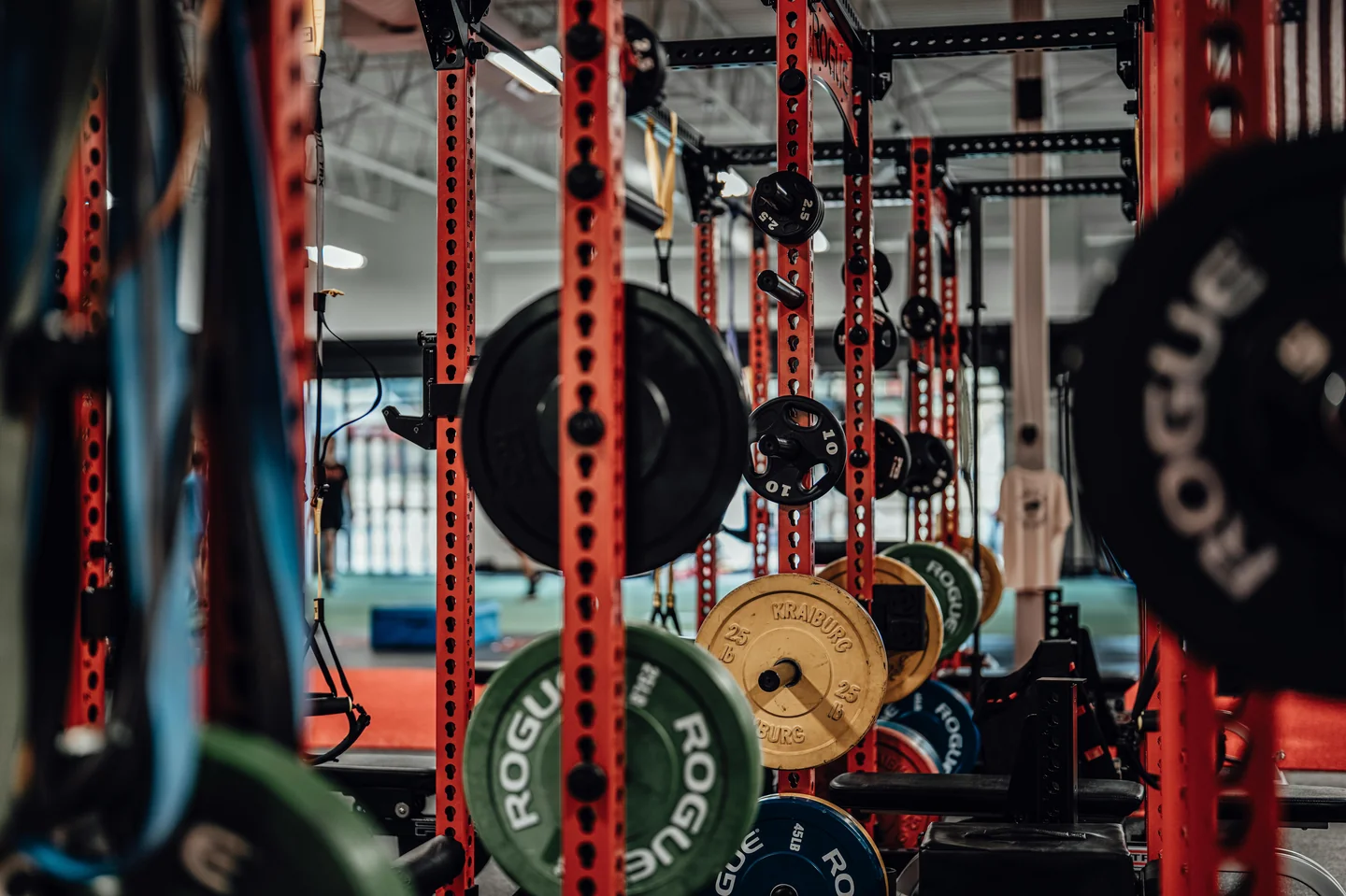 Squat racks loaded with bumper plates in a barbell gym